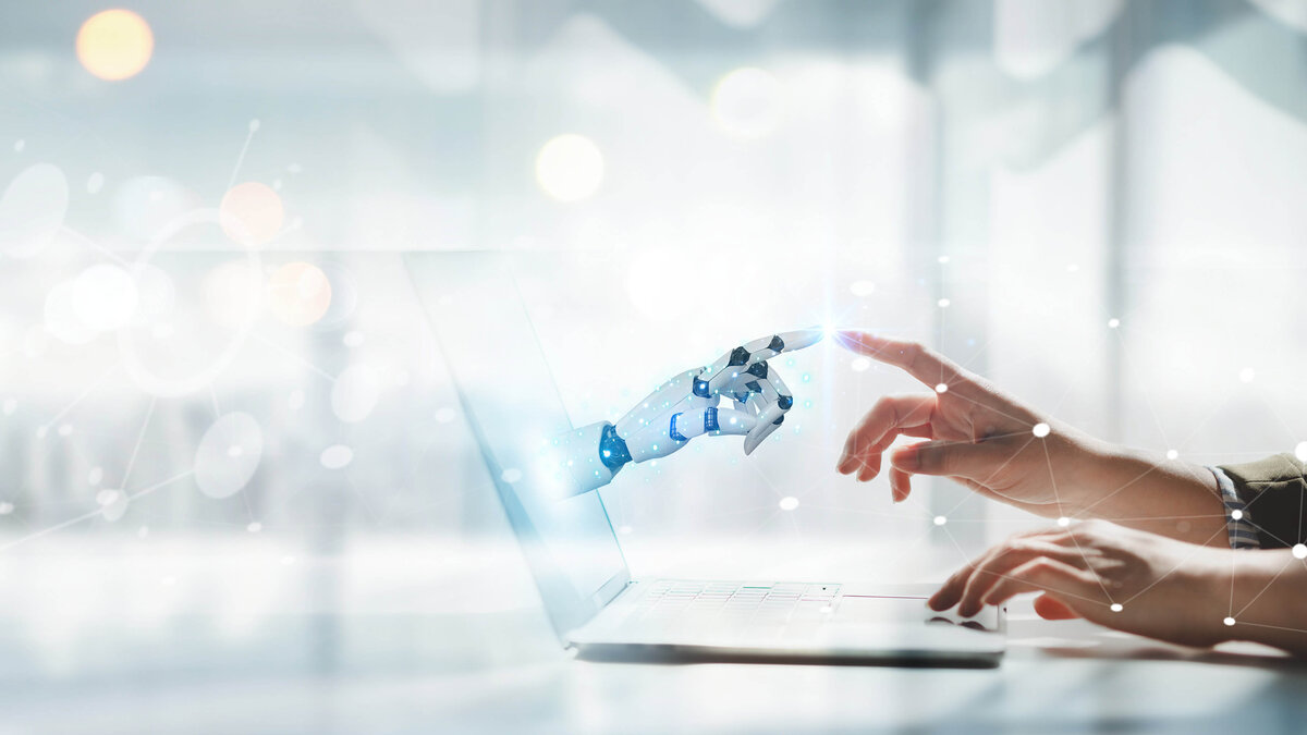 Roboterhand trifft Menschenhand in der KI-Arbeitswelt