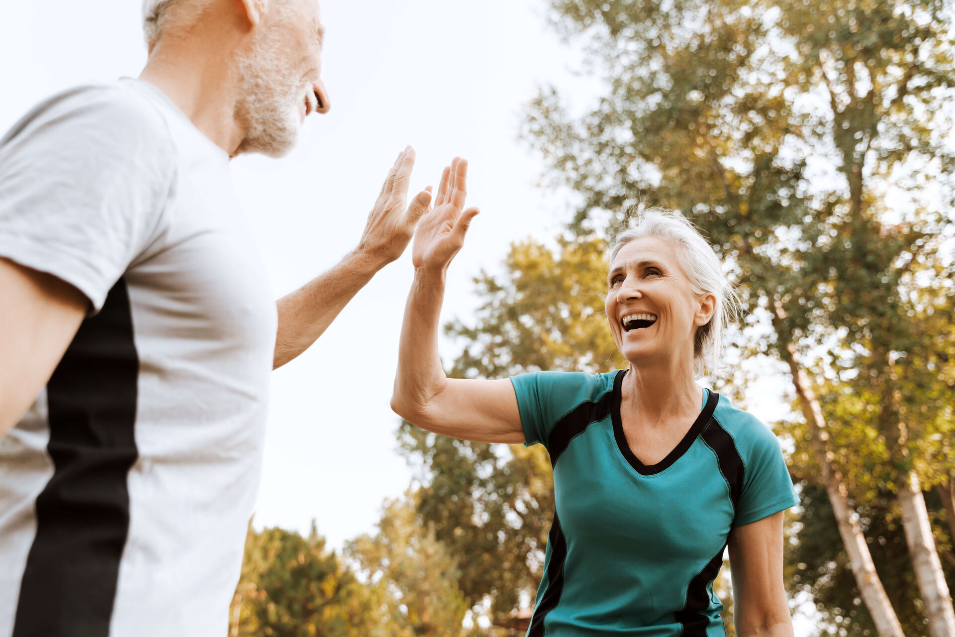 Zwei Personen klatschen beim Sport die Hände zusammen