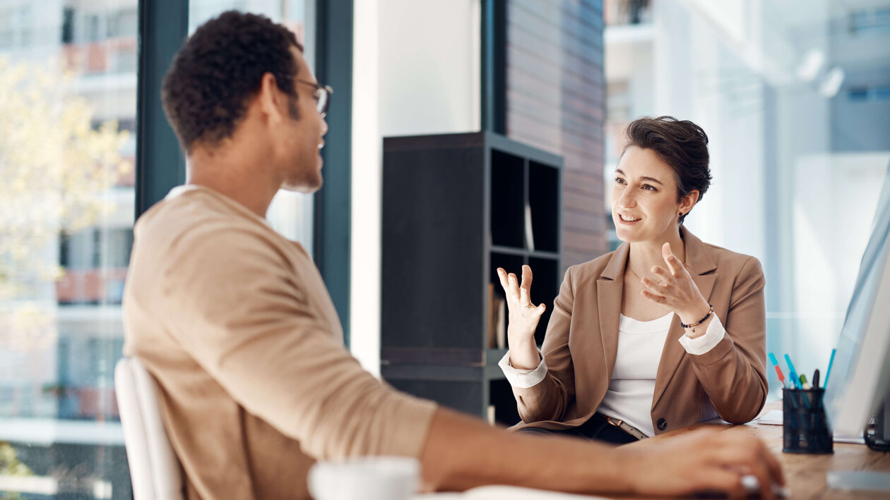 Mann und Frau in einem vertrauensvollen Gespräch im Büro