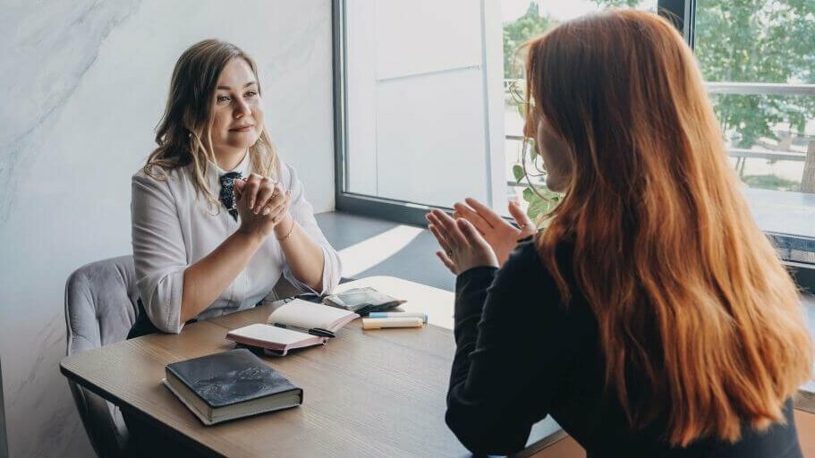 Gespräch am Tisch zwischen zwei Frauen